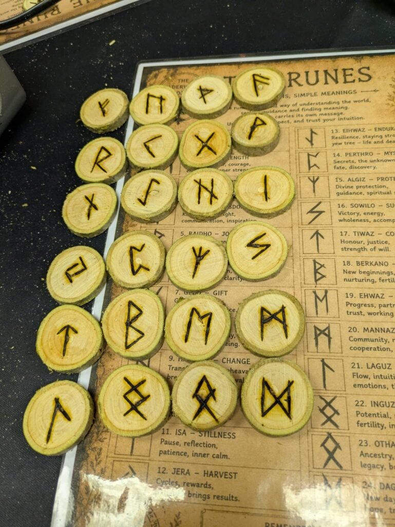 Handmade Elder Futhark rune pieces used in an Elderwood workshop
